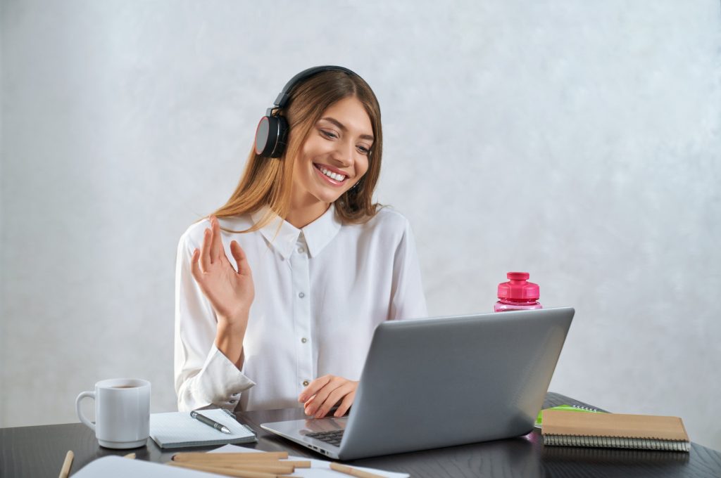 woman-waving-and-talking-during-online-education-on-laptop.jpg